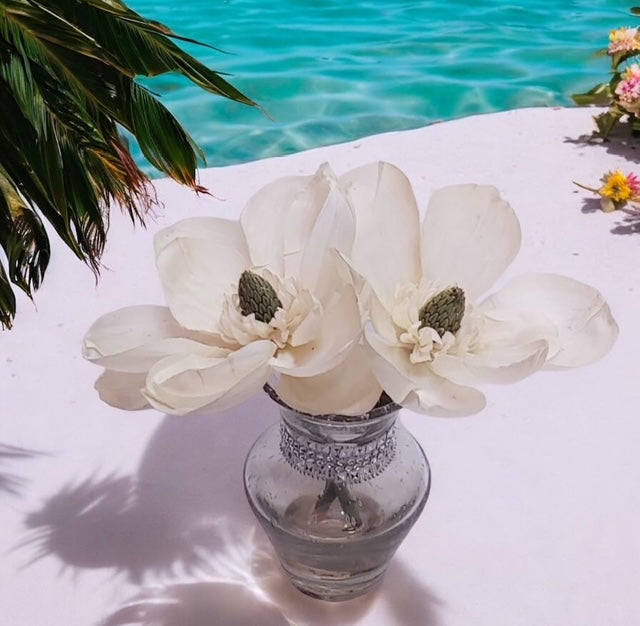Faux cream color flowers in a glass vase